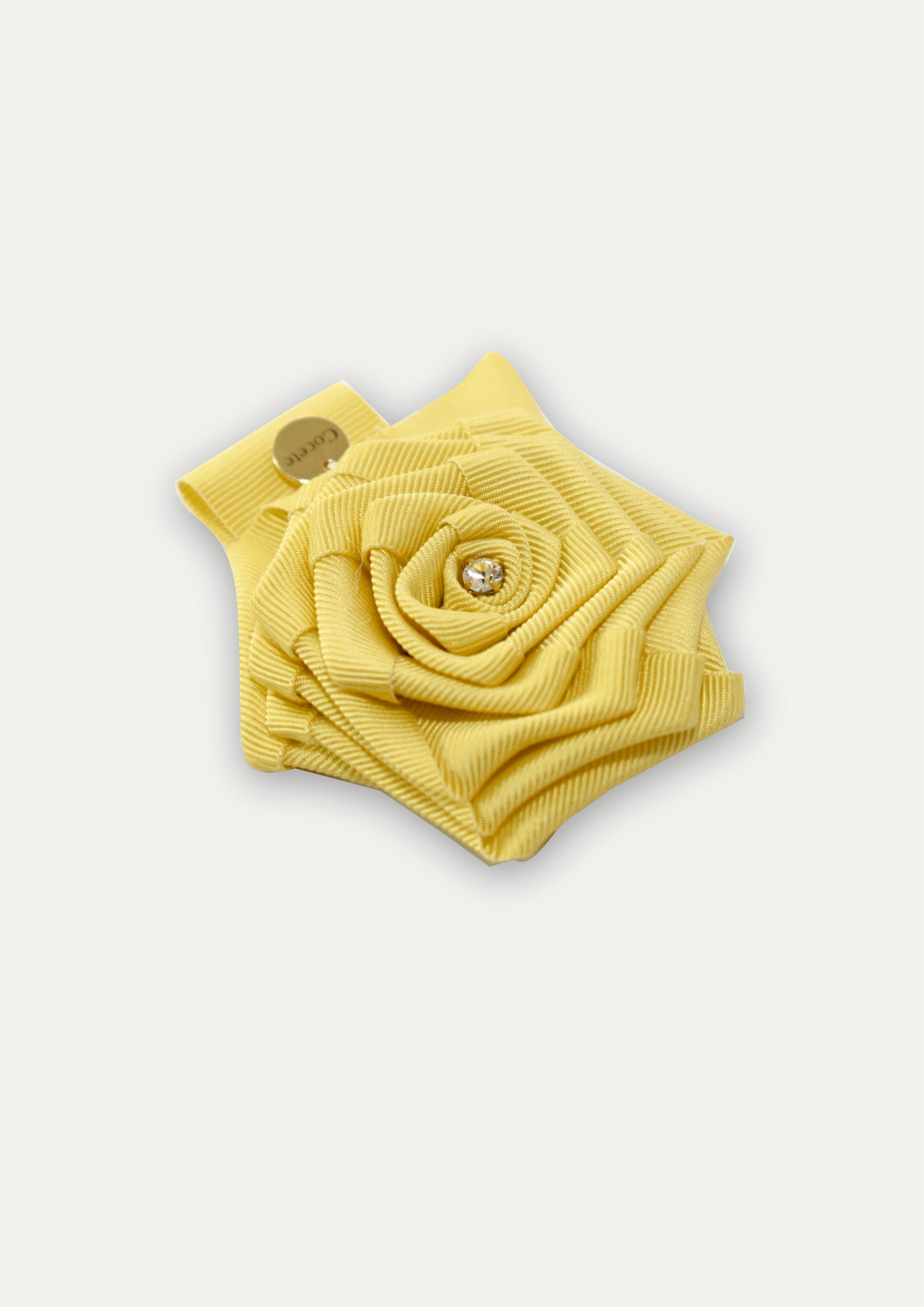 Handmade in UK: Vibrant yellow fabric rose hair clip for girls with a sparkling crystal center and a gold COCETE brand charm.