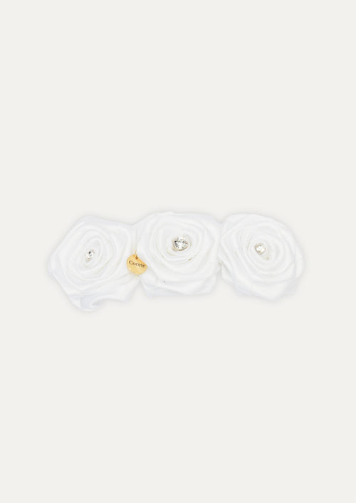 Handmade white triple fabric rose hair clip for girls, featuring crystal centers and a small gold COCETE brand charm.