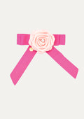 Handmade fuchsia pink ribbon hair bow for girls, decorated with a pale pink satin rose, a crystal center, and a gold COCETE brand charm.