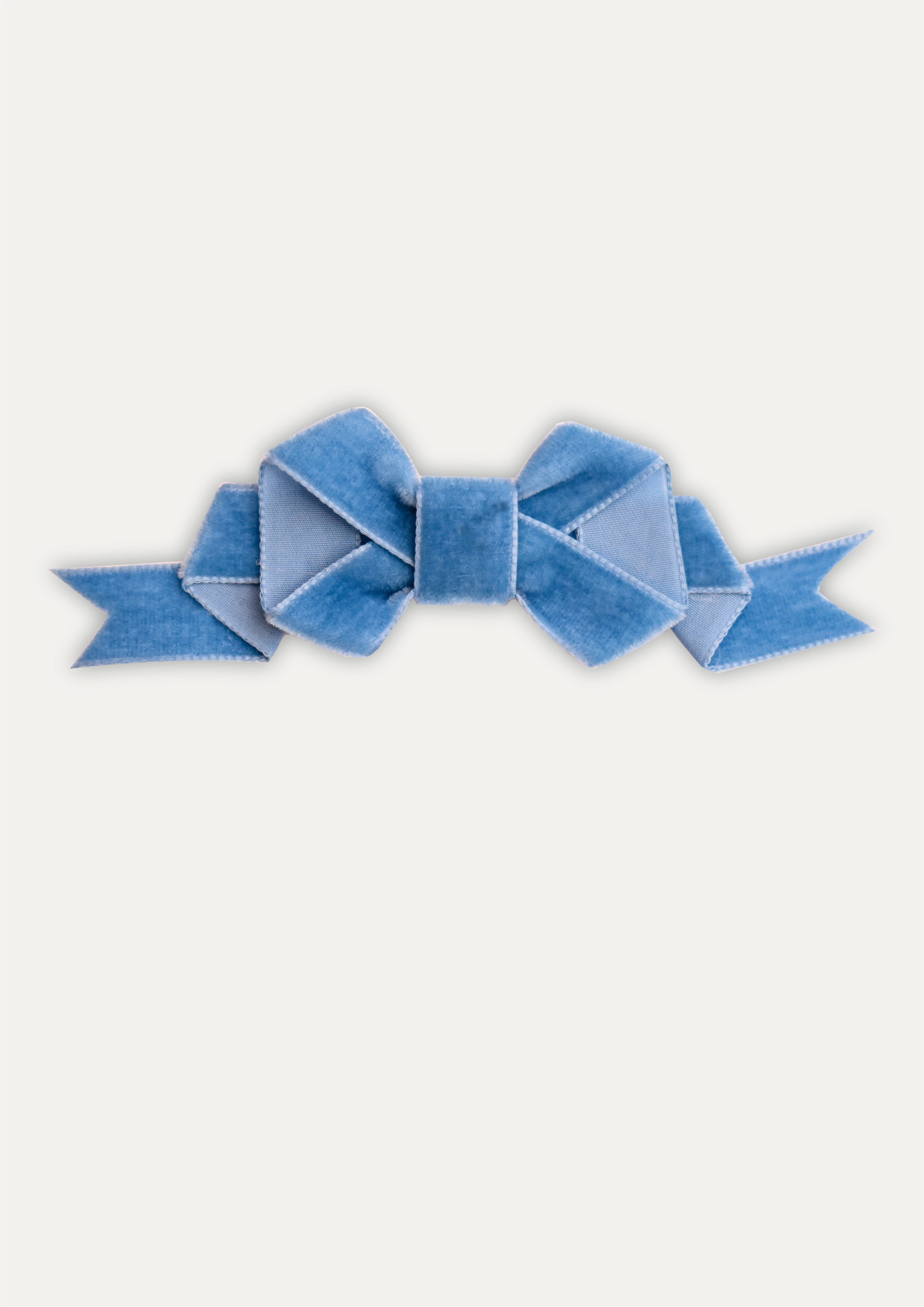 Blue bow on a white background
Handmade aqua blue velvet hair bow clip on a white background.
Little girl wearing a large aqua velvet bow hair clip in her blonde hair.
Close-up of soft velvet fabric and secure metal clip of the aqua hair bow.