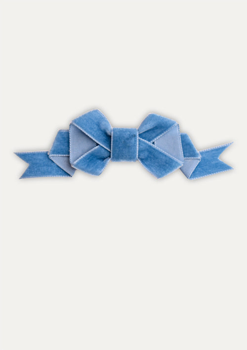 Blue bow on a white background
Handmade aqua blue velvet hair bow clip on a white background.
Little girl wearing a large aqua velvet bow hair clip in her blonde hair.
Close-up of soft velvet fabric and secure metal clip of the aqua hair bow.